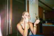(chez Zak Smith, August 2002) Katie Condon with two halves of a pea pod