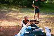 (The Farm, July 2002) Sasha Garofalo with rifle