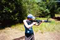 (Shooting at Farm, July 2003) Sasha shoots the AR-15 standing