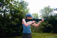 (Shooting at Farm, July 2003) Sasha shoots the AR-15 standing
