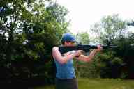 (Shooting at Farm, July 2003) Sasha shoots the AR-15 standing